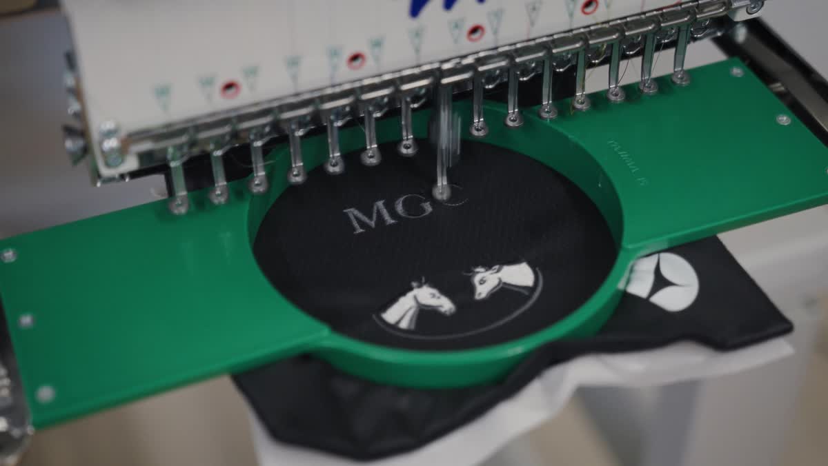 MGC crest being embroidered onto a garment